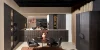A modern kitchen with dark cabinets and a round dining table, Nolte Küchen.