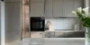 A modern kitchen with gray cabinets and a marble island from the Nolte Kitchen collection.