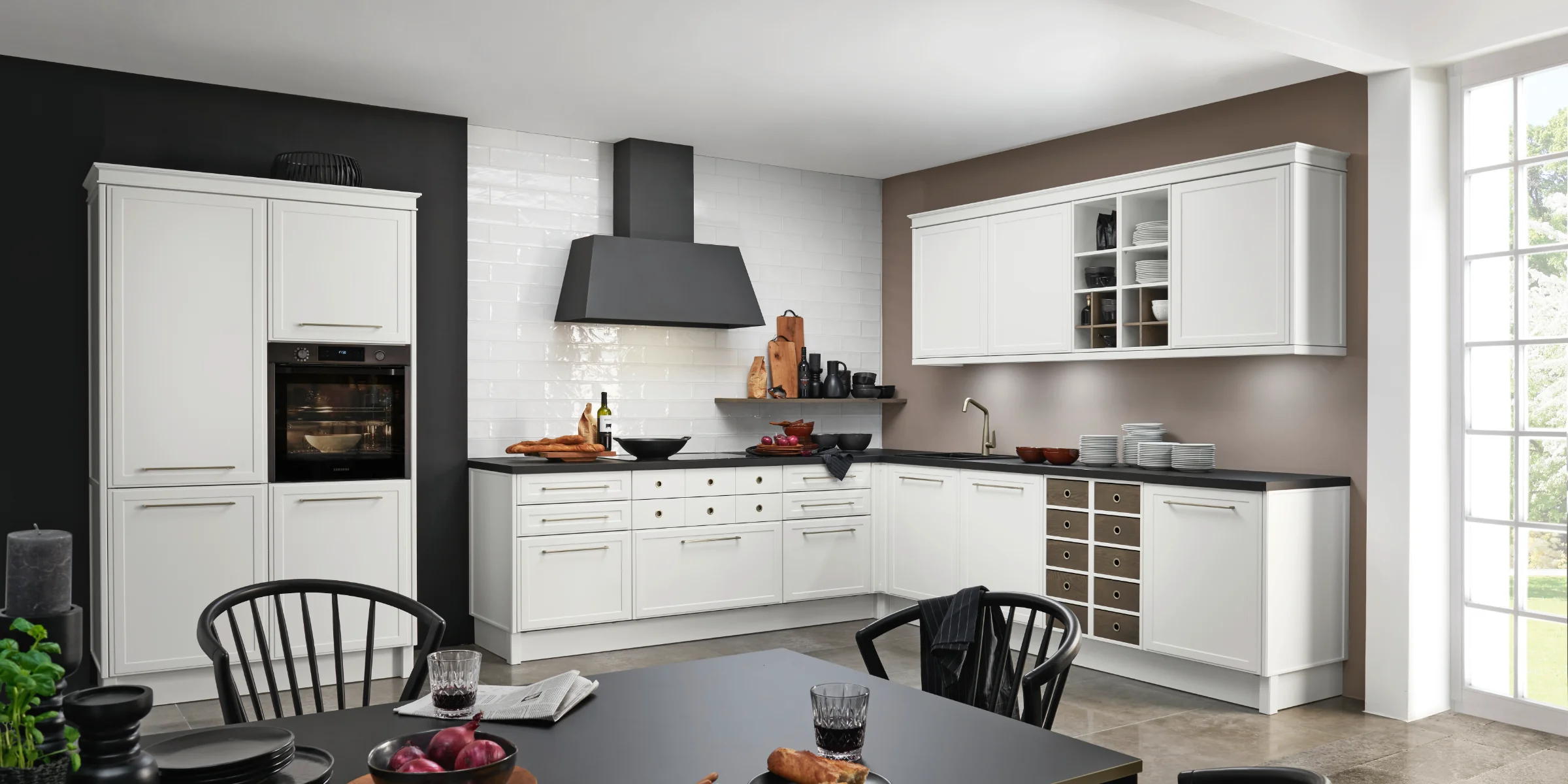 Eine moderne Küche mit weißen Schränken und einer großen Fensterfront. Nolte Küchen.