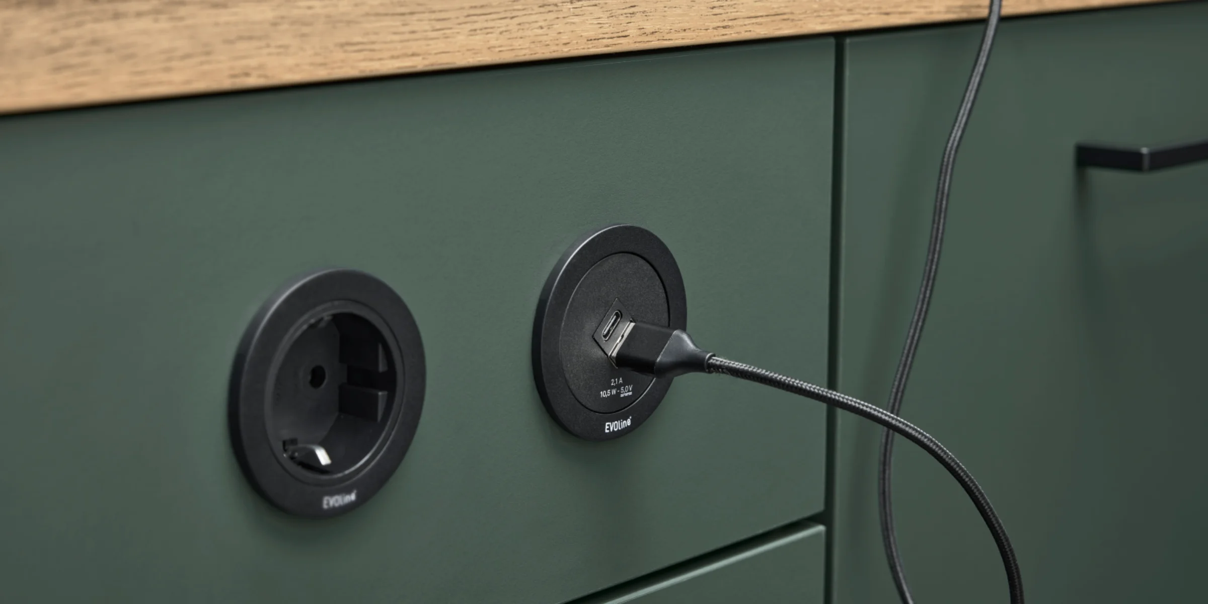 A green kitchen unit with built-in outlets showcases modern design by Nolte Kitchen.