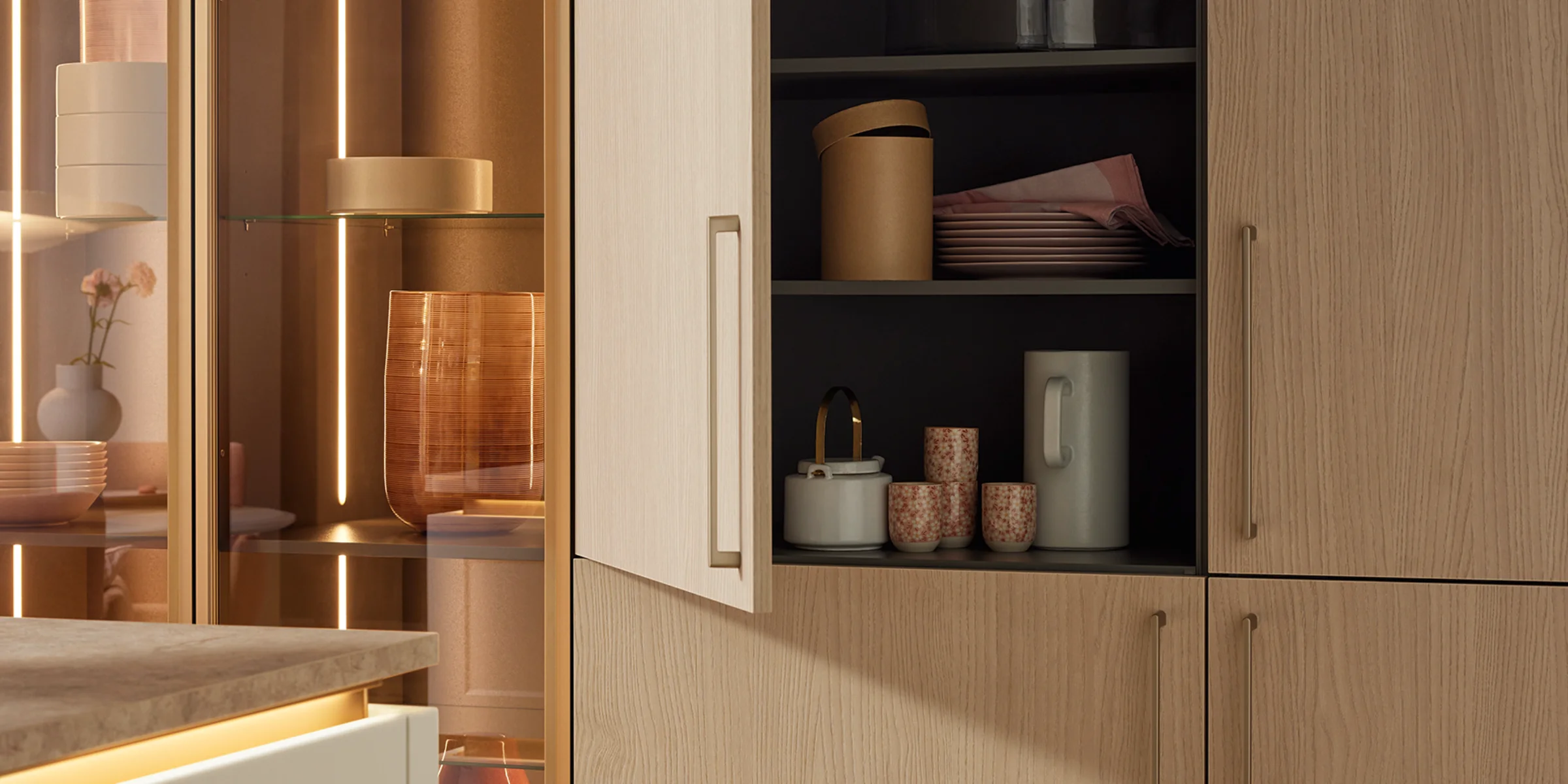 Hochschrank mit Auszugssystem im modernen Küchenraum, ausgestattet mit Fronten aus dem Nolte Küchen Frontenprogramm Soft Lack in der Ausführung Weiß Softmatt. Der Schrank beinhaltet einen integrierten Backofen sowie einen seitlich herausziehbaren Vorratsschrank mit Metallkörben, ideal zur Aufbewahrung von Lebensmitteln. Die matte, grifflose Front sorgt für ein minimalistisches, elegantes Design in zeitgemäßem Ambiente.