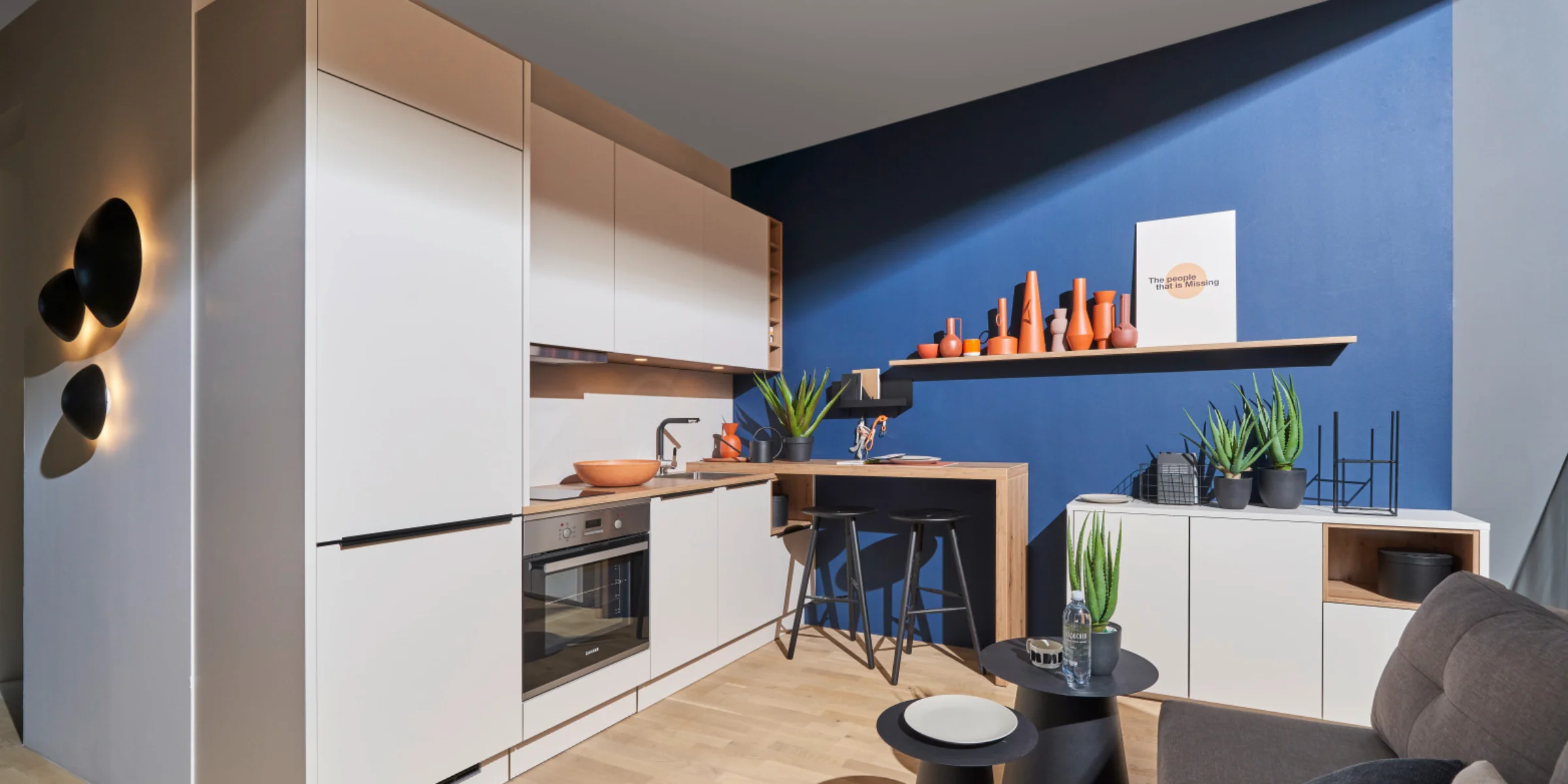 Eine moderne Küche mit weißen Schränken und blauen Wänden, gestaltet von Nolte Küchen.