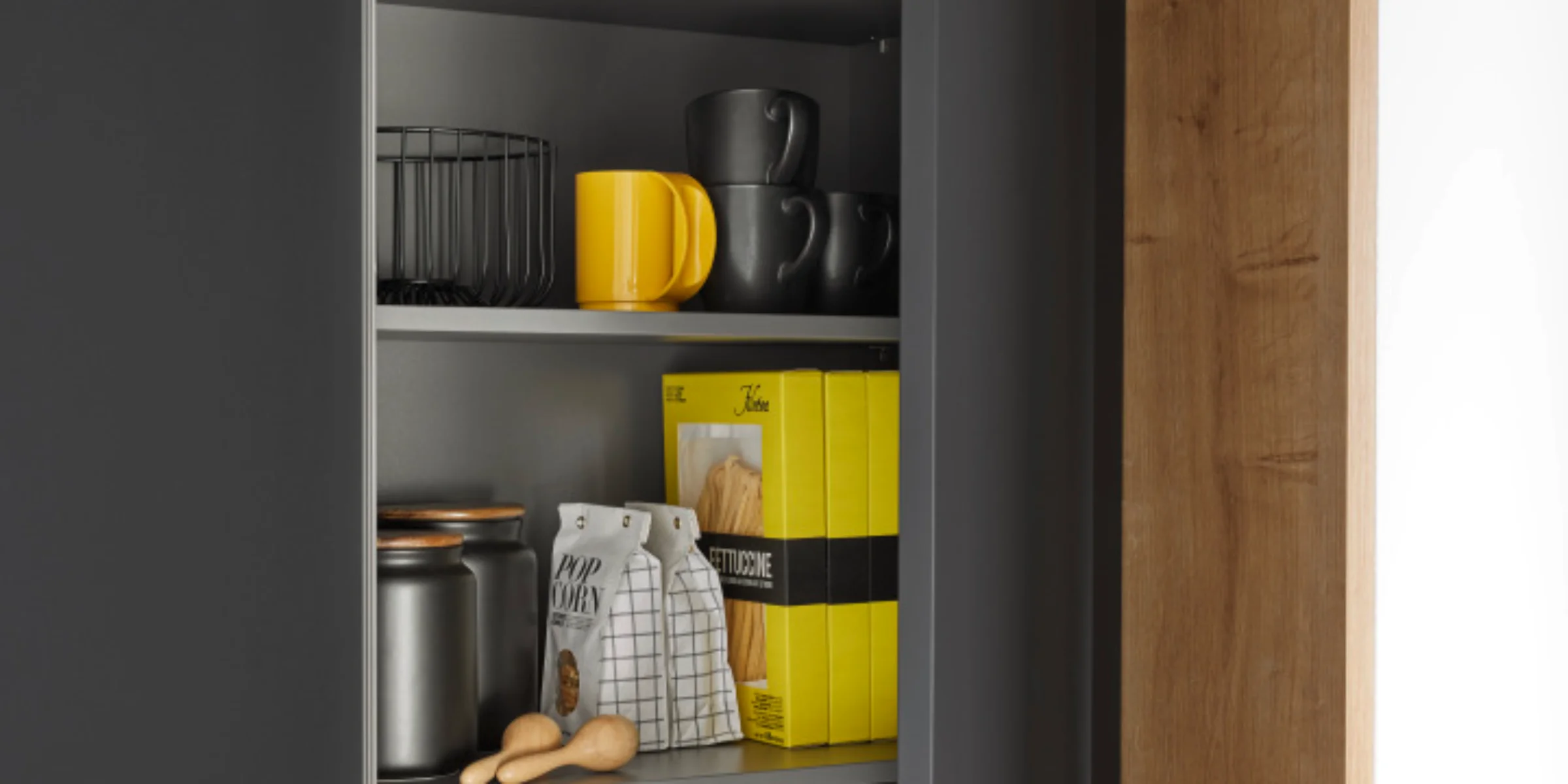 Ein offener Küchenschrank mit Geschirr und Lebensmitteln, gestaltet von Nolte Küchen.