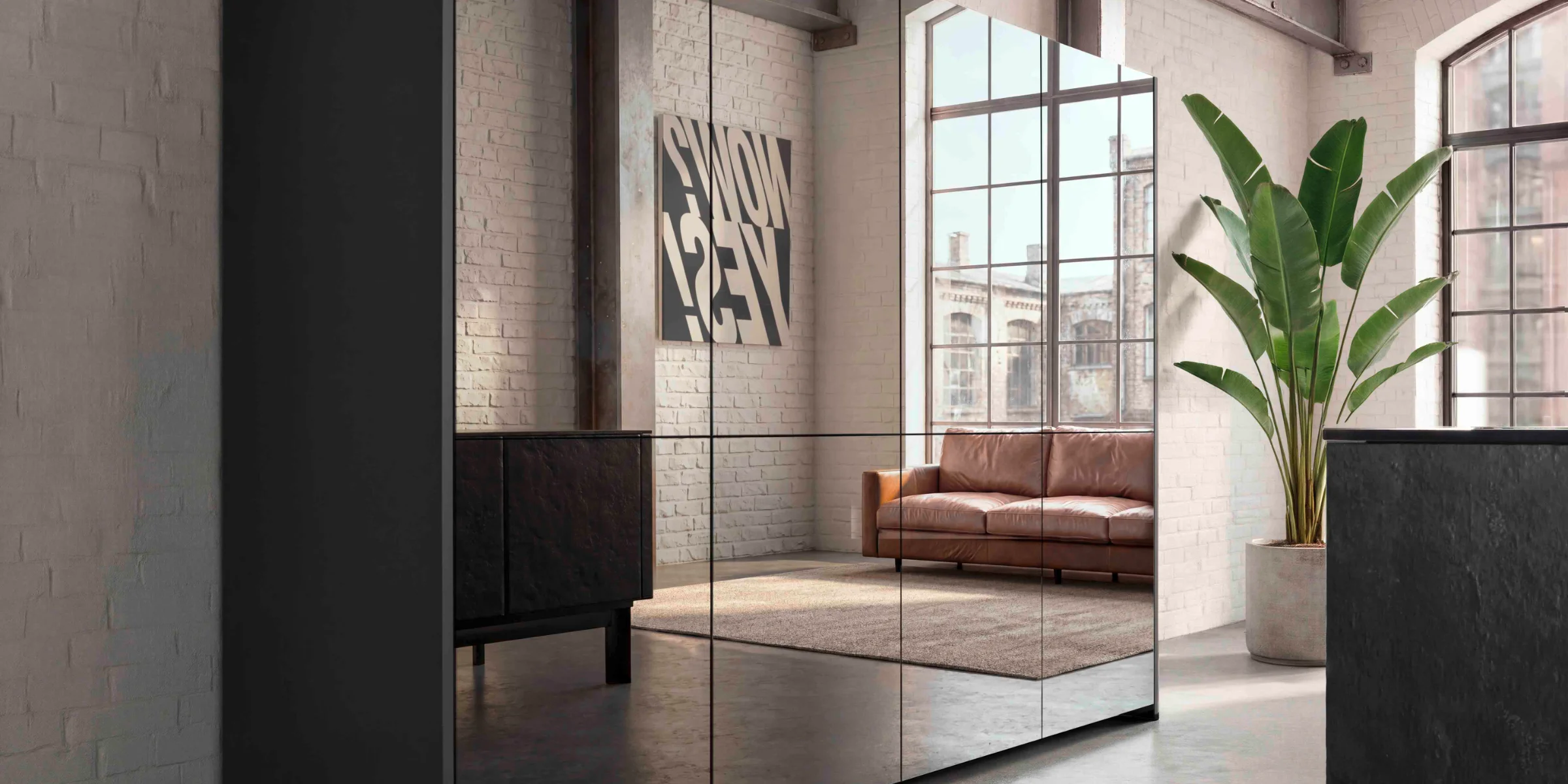 Moderne Loft-Wohnung mit Spiegelwand, grauem Schrank und Ledersofa. nolteneo.