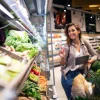 A woman selects fresh vegetables in a supermarket while holding a tablet.
