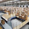 A large warehouse full of boxes and conveyor belts, associated with Nolte Kitchens.