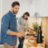A couple cooking in a modern kitchen, styled by Nolte Kitchen.