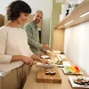 Eine Frau und ein Mann bereiten Sushi in einer modernen Küche von Nolte Küchen zu.