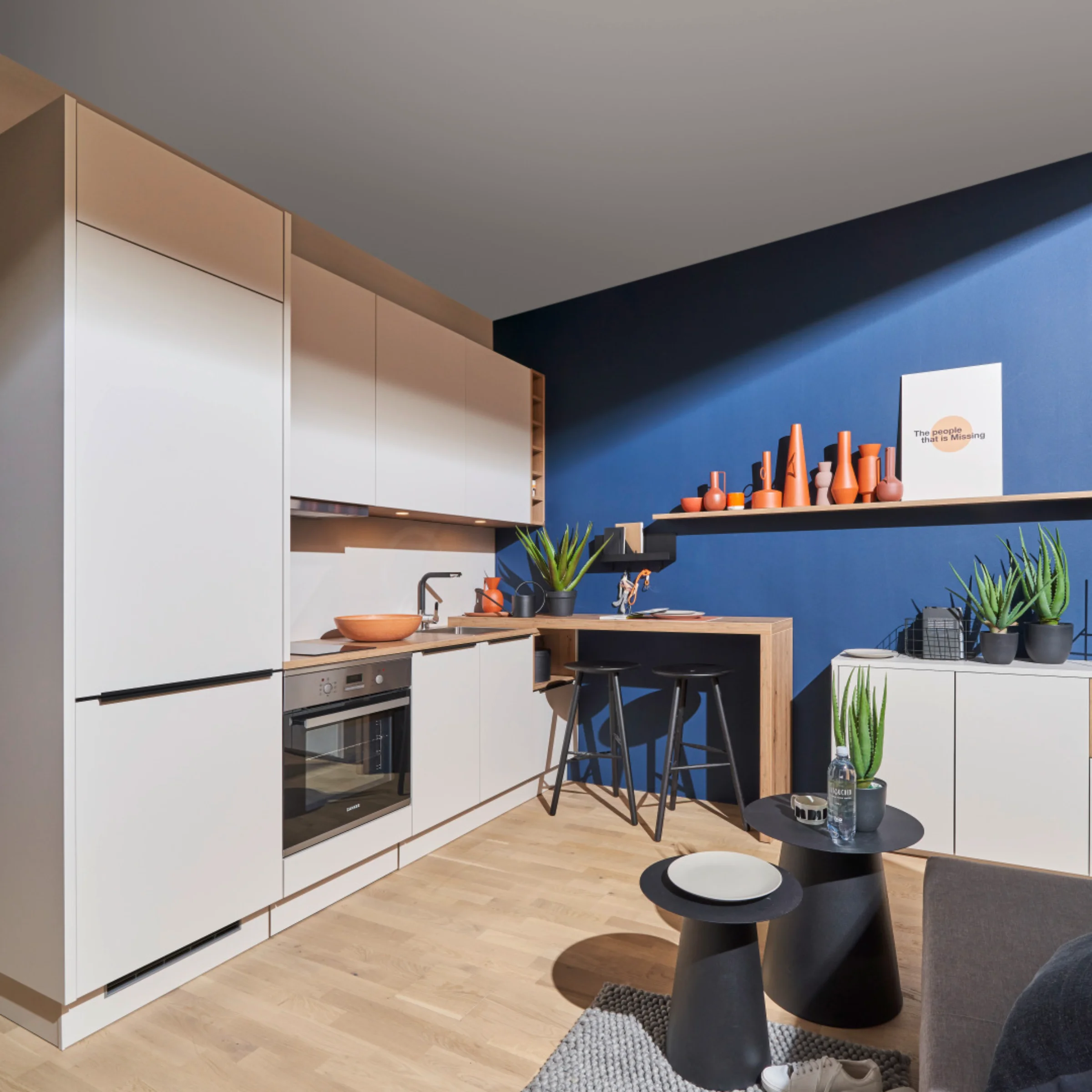 Eine moderne Küche mit weißen Schränken und blauen Wänden, gestaltet von Nolte Küchen.