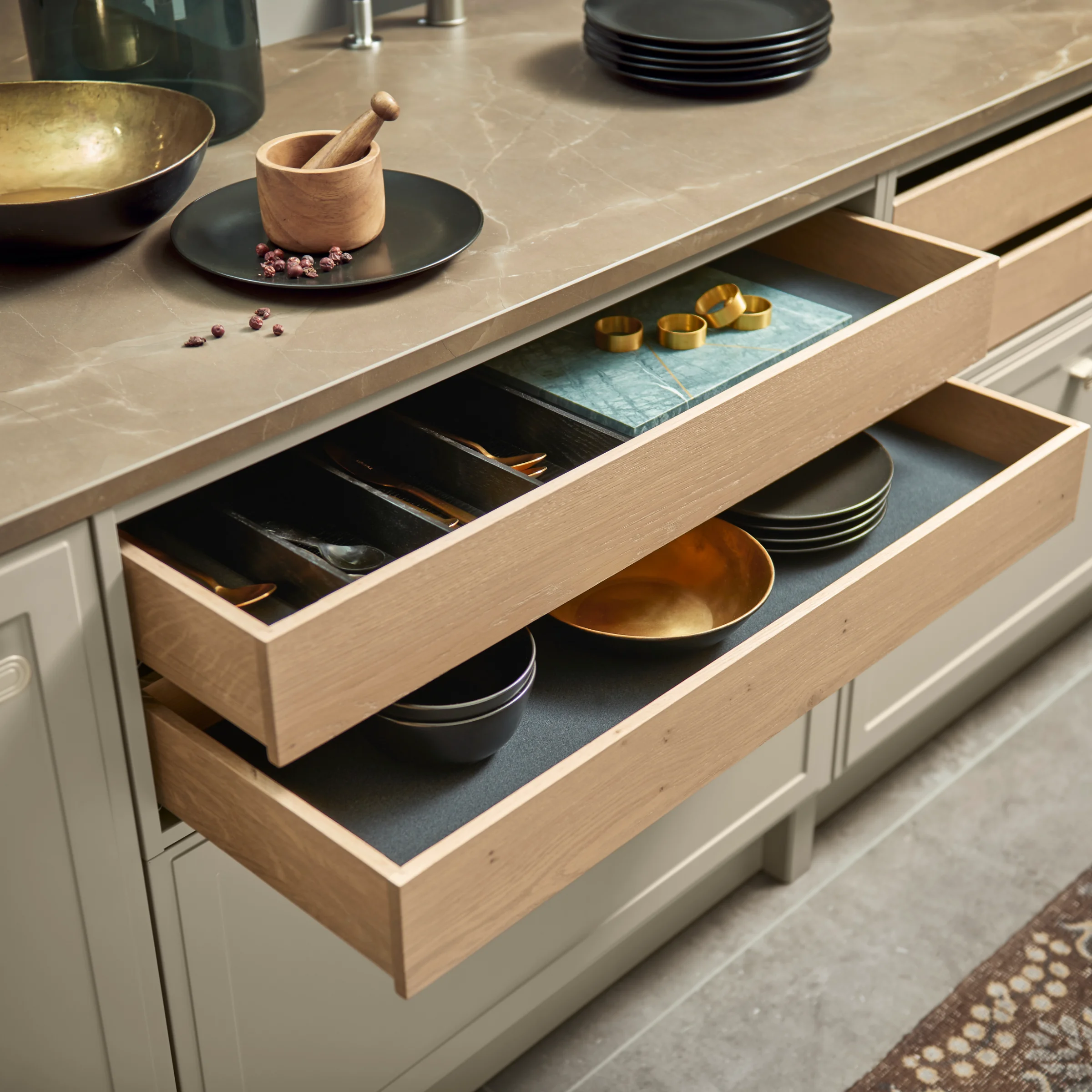 Una cocina elegante con cajones abiertos muestra soluciones de almacenamiento elegantes de Nolte Cocina.