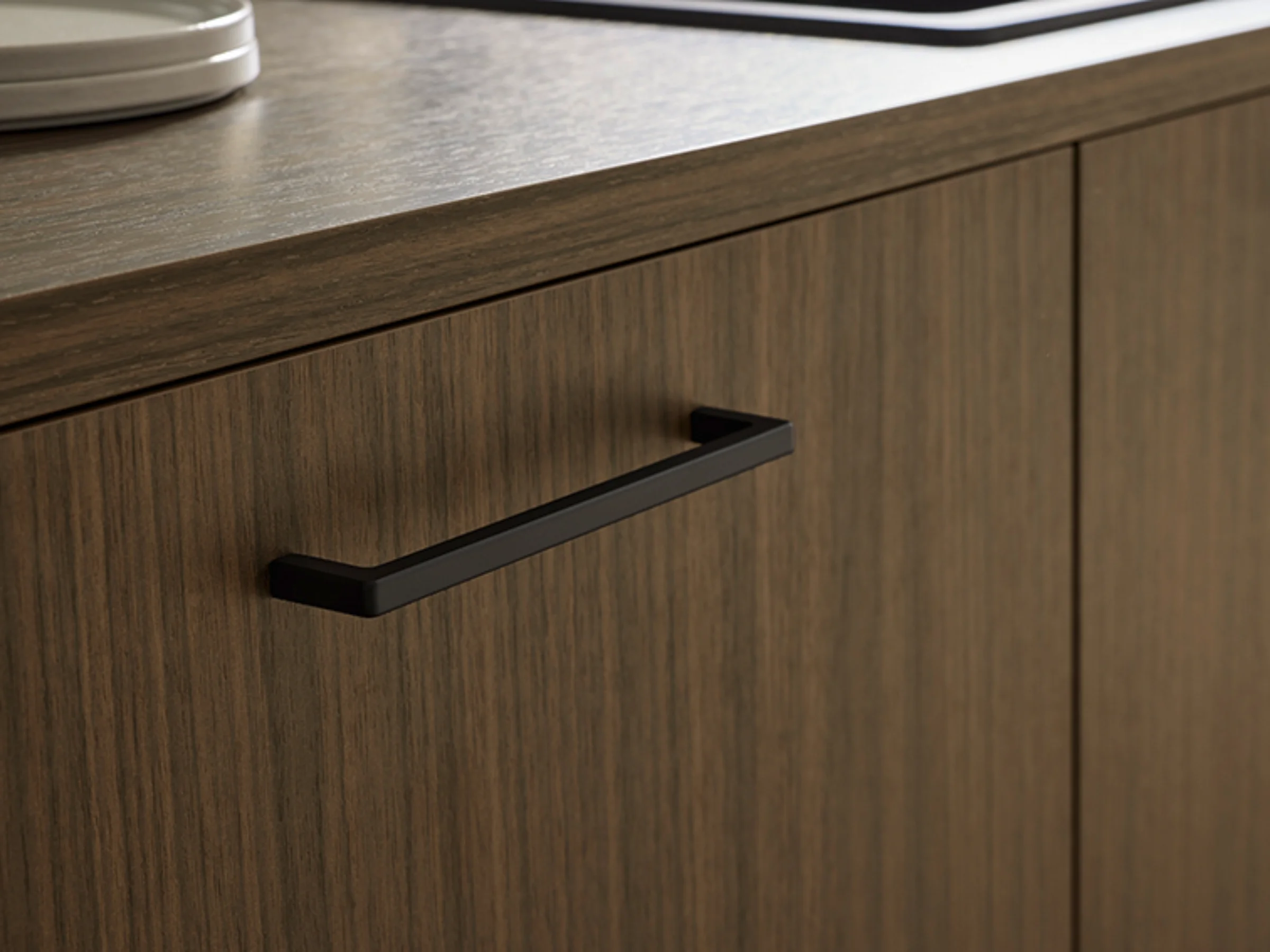 Wooden kitchen drawer front with modern handle. Nolte Kitchens.