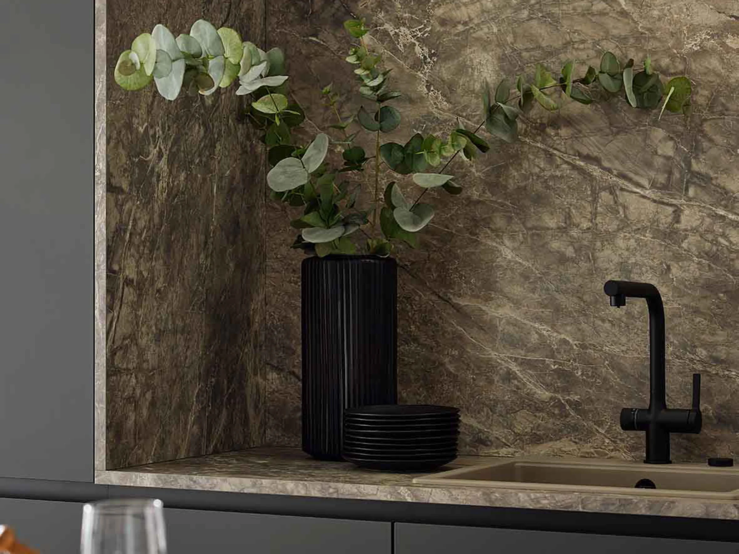 A stylish kitchen with marble look, black faucet, and green plants. Nolte Kitchen.