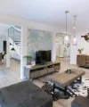 Ein modernes Wohnzimmer mit Holzmöbeln und Weltkarten-Dekor an der Wand, Nolte Living.