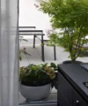A modern outdoor area with plants and seating on a terrace.