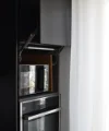 A modern kitchen cabinet with oven and microwave, elegantly designed by Nolte Kitchen.