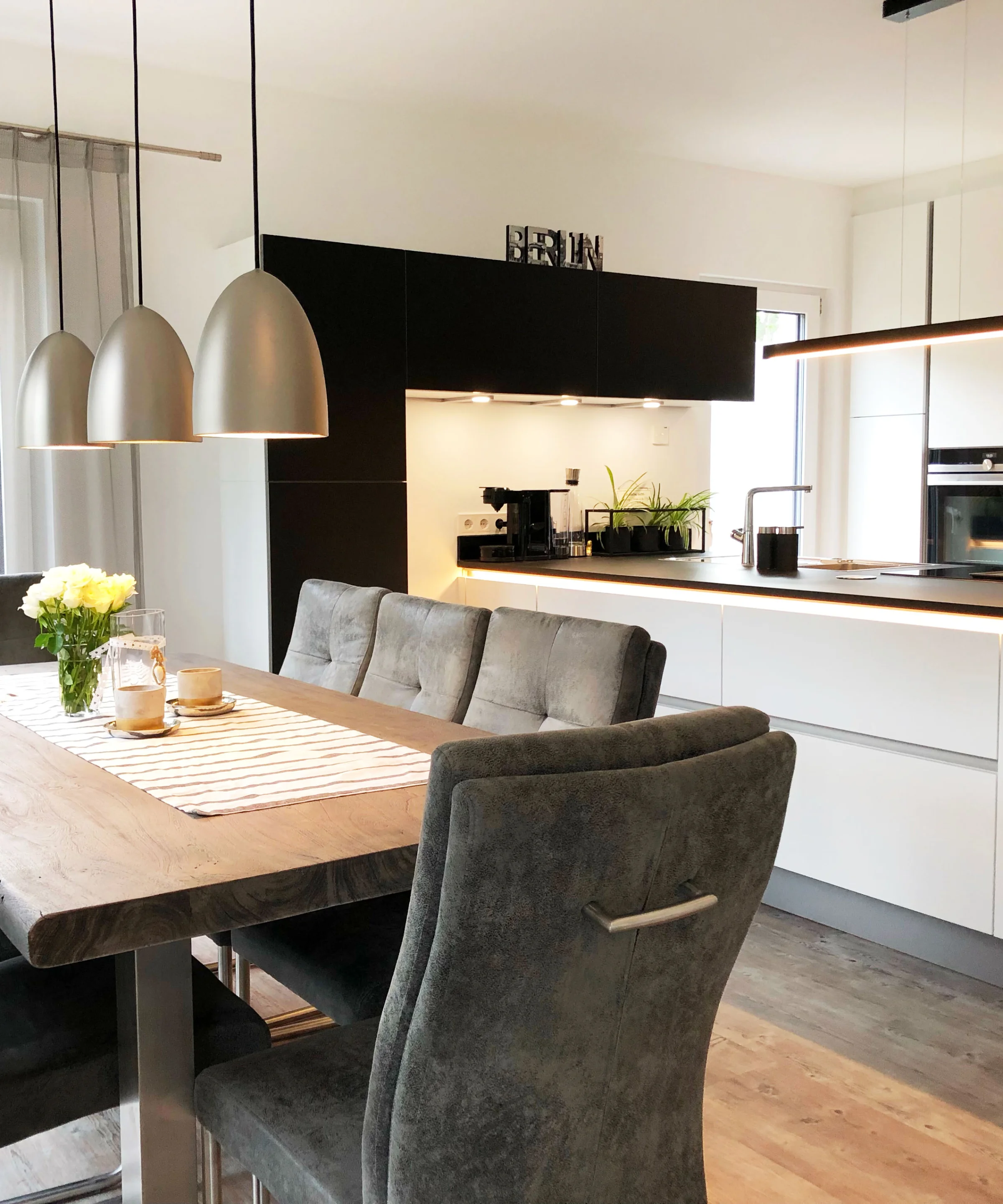 Eine moderne Küche mit Essbereich und Holzdetails, gestaltet von Nolte Küchen.